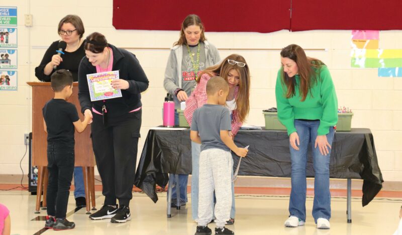 Kindergarteners receive praise from principals Mrs. Novak and Mrs. Hills.
